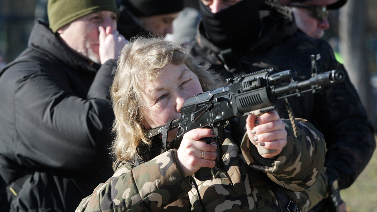 A woman attends a military exercise for territorial defense amid the tension on the border with Russia, in Ukrainian capital Kyiv, Ukraine 13 February 2022. Members of 'Right Sector" nationalist party held an open military training for residents amid threat of Russian invasion. (Photo by STR/NurPhoto via Getty Images)